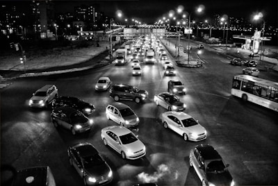 Surveillance cameras monitoring a busy city intersection at night.