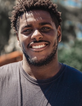 selective focus of man smiling during daytime