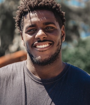 selective focus of man smiling during daytime