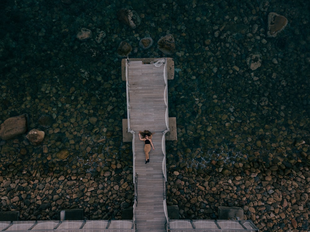 aerial view of woman laying on dock