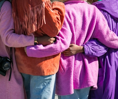 four person holding each others waist at daytime