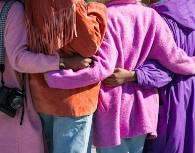 four person holding each others waist at daytime