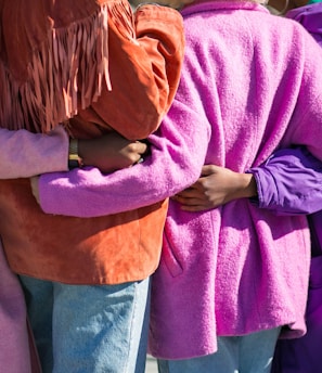 four person holding each others waist at daytime