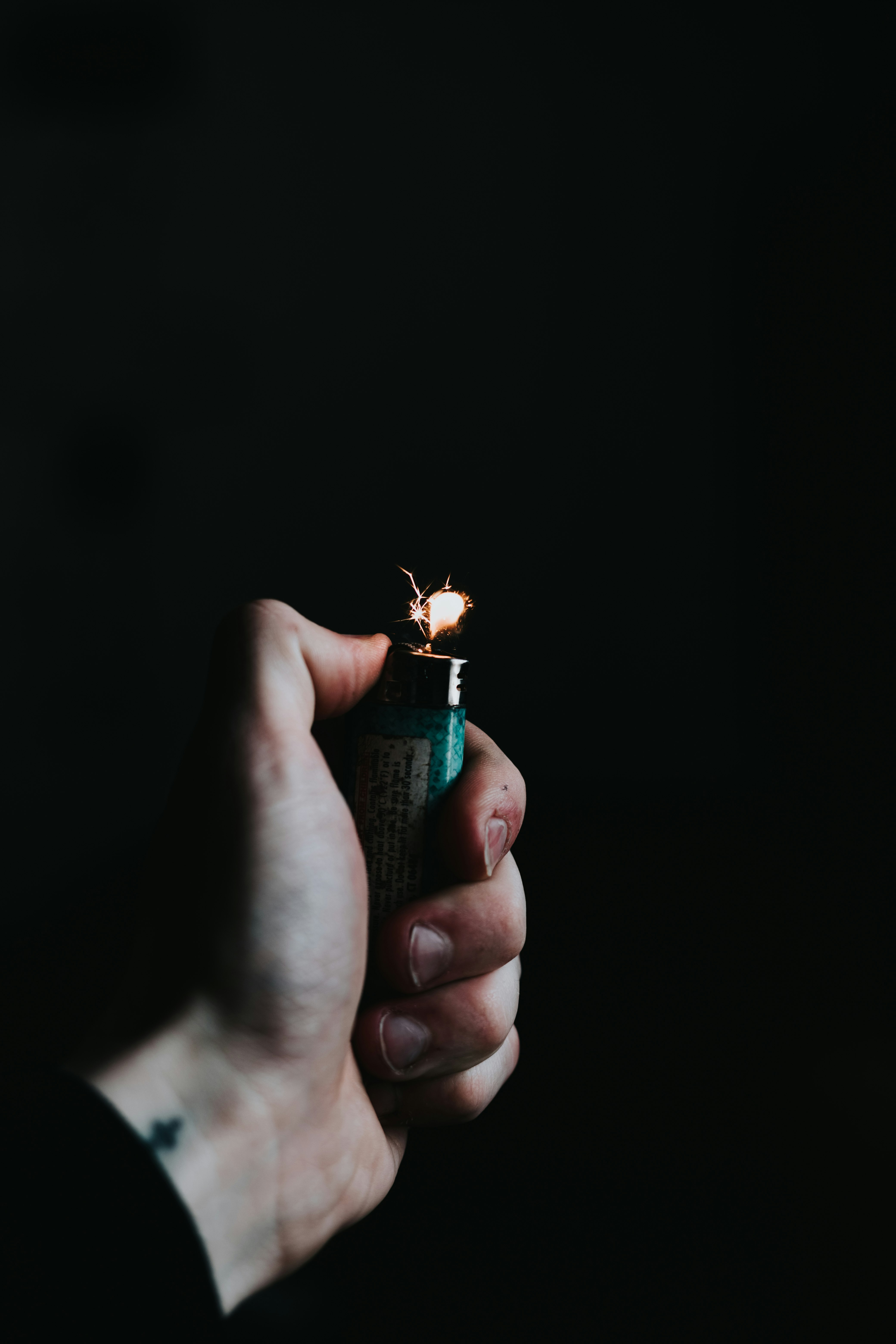 person holding green lighter