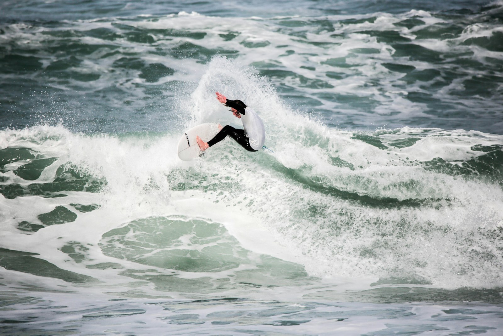 Tamron SP 150-600mm F5-6.3 Di VC USD G2 sample photo. Person surfing on beach photography