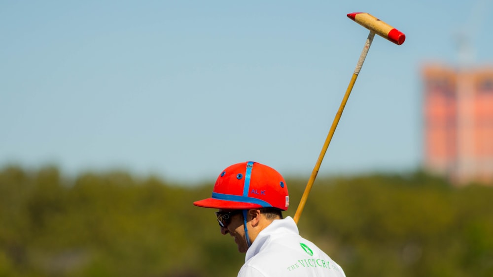 man holding brown wooden stick during daytime photo