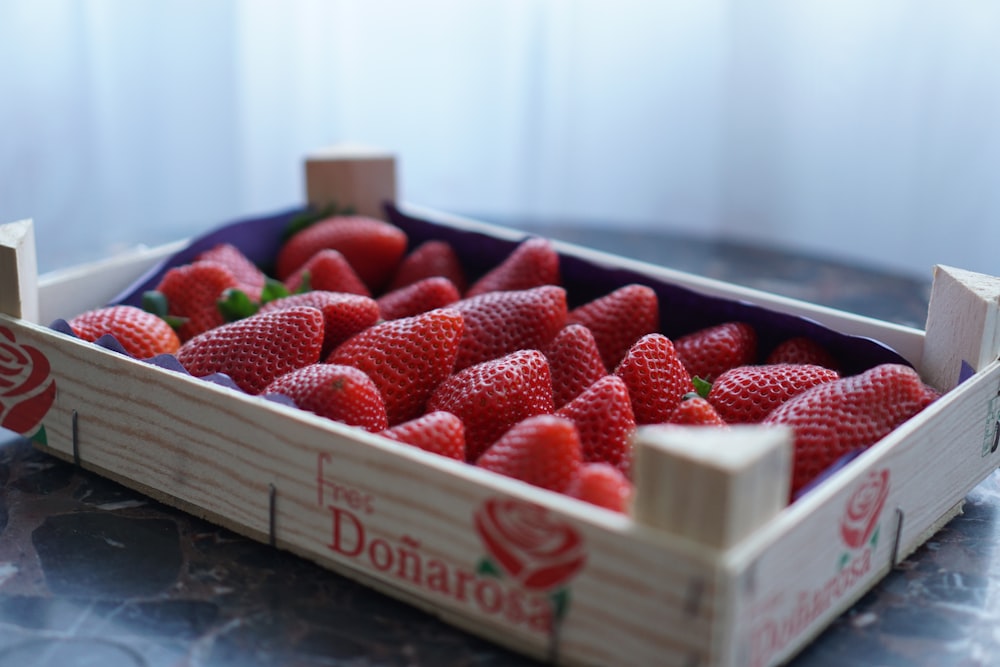strawberry fruits in brown wooden tray