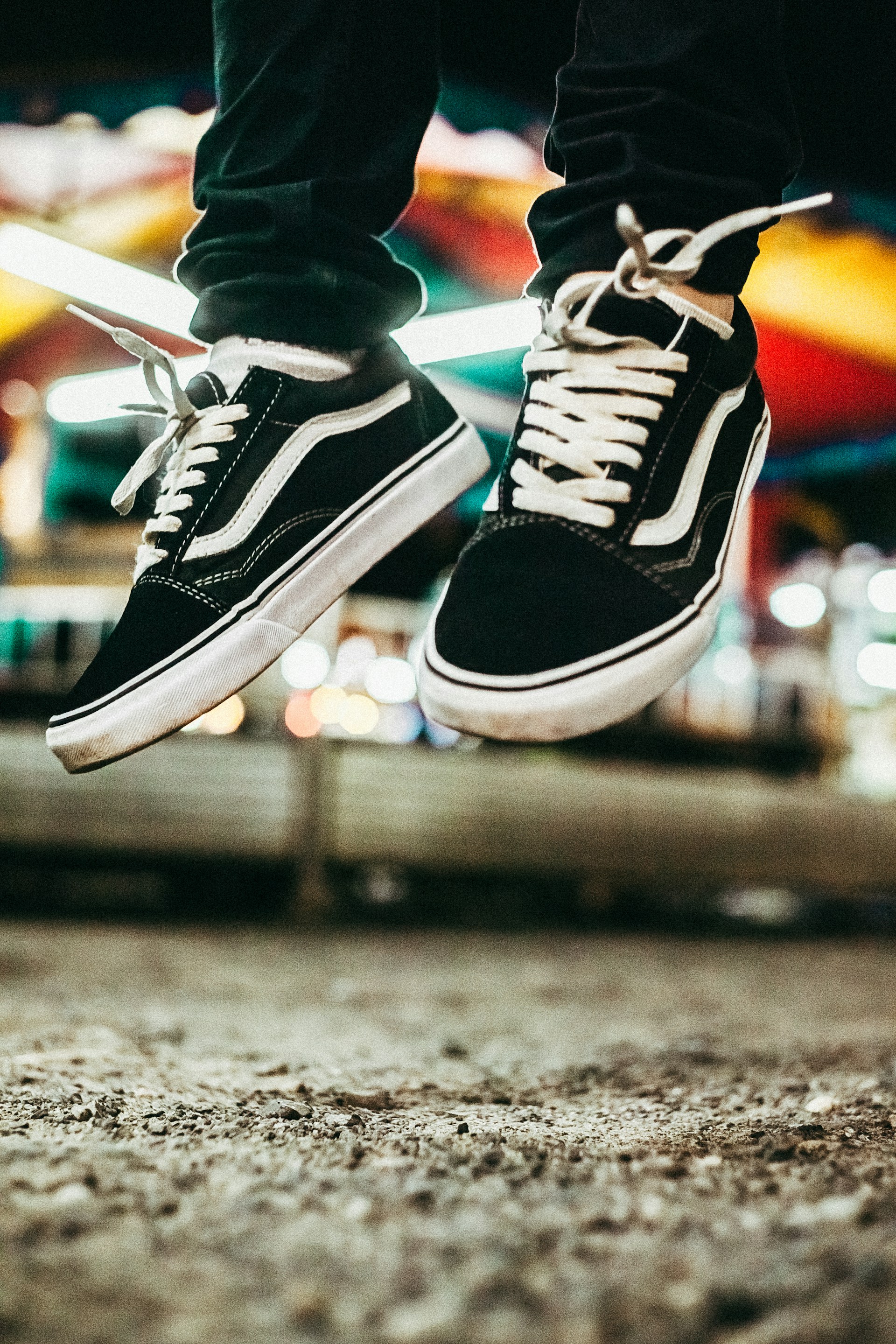 A lifestyle shot of a group of friends wearing lunakicks sneakers during a nighttime city stroll, capturing the essence of urban adventure.
