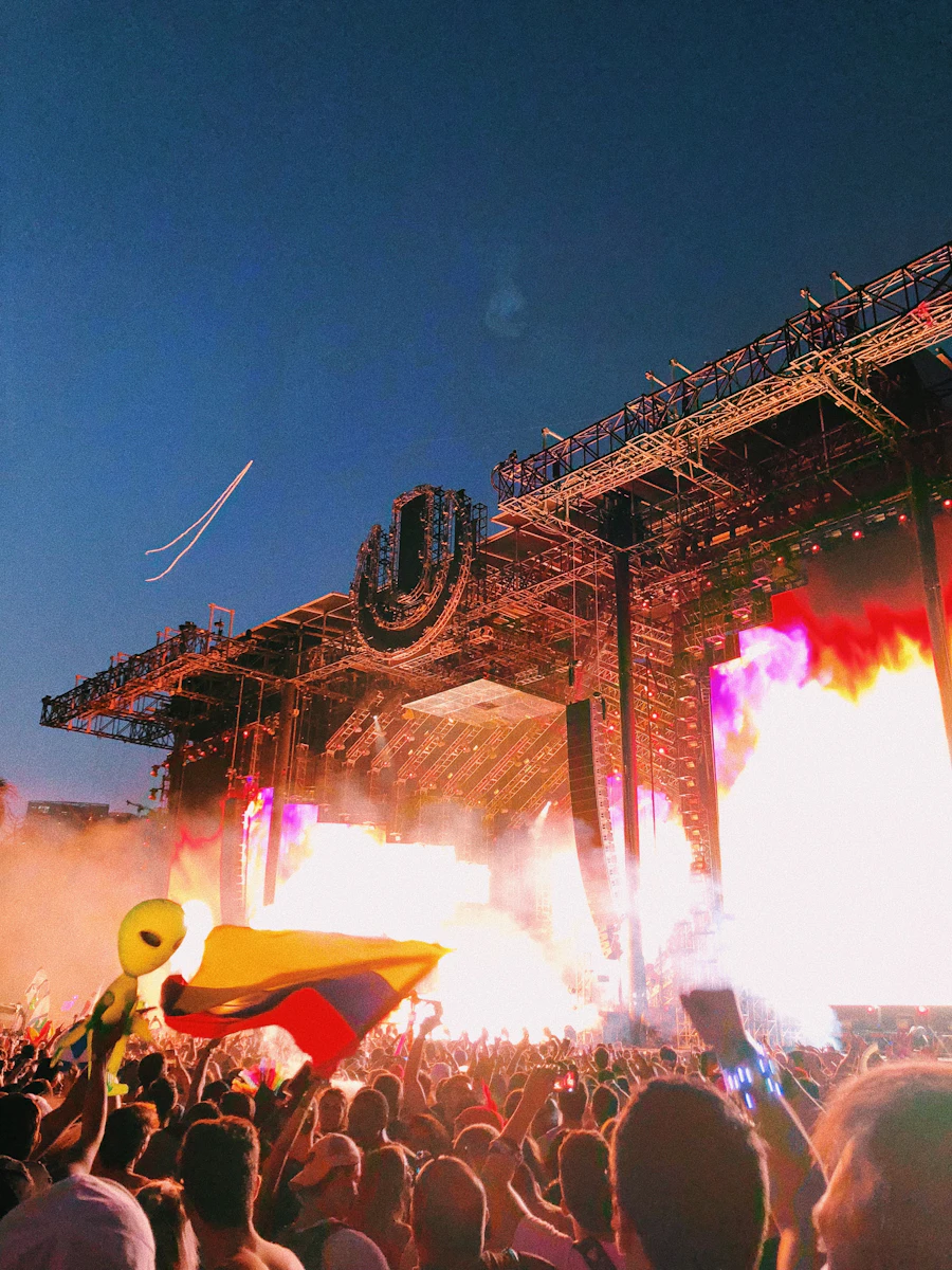 Flame effects erupting across a stage in front of a crowd