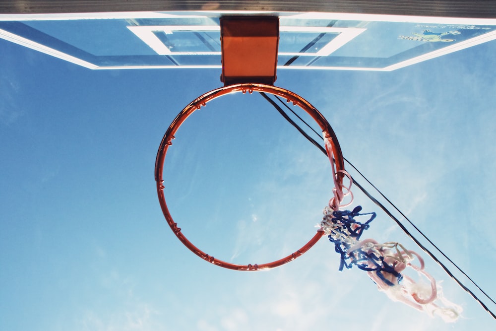low angle view of red basketball rim and board