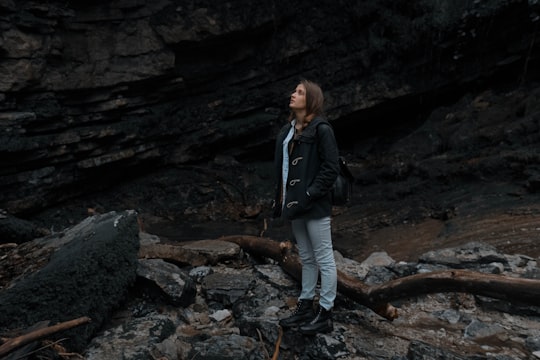 woman standing near rock formation in Sochi Russia