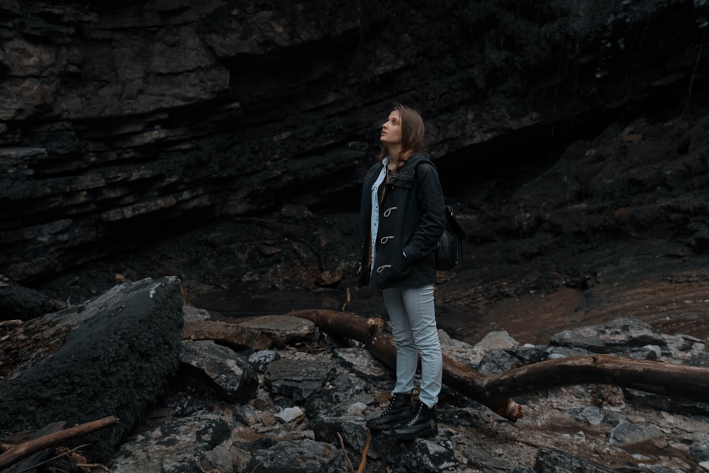 woman standing near rock formation