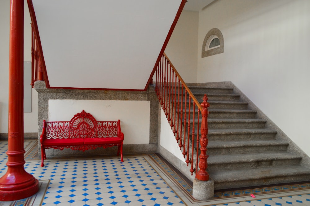 red steel bench near stair