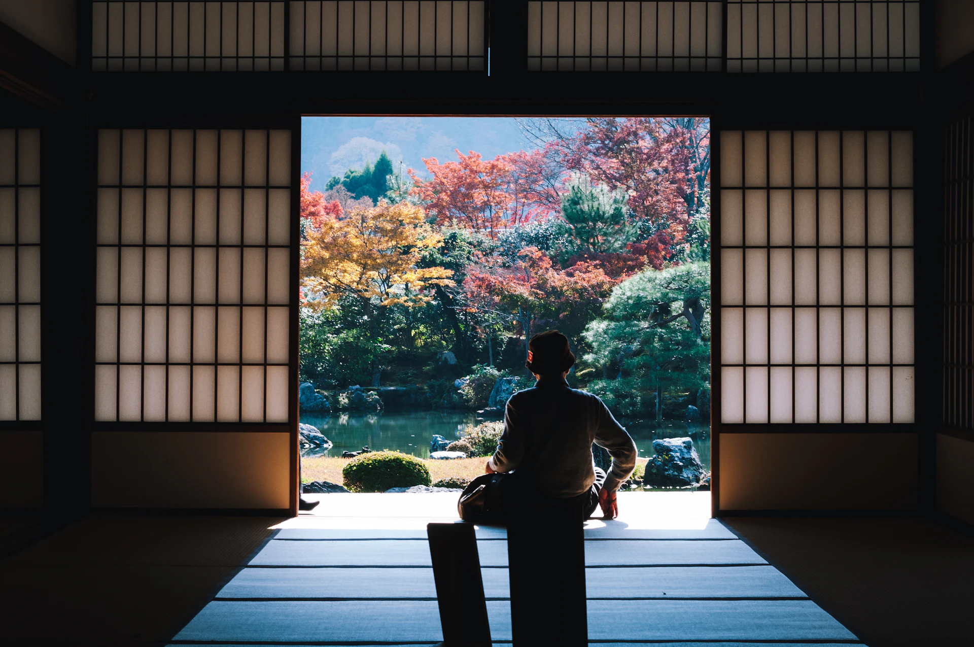 A quiet Japanese street with warm lantern light and traditional wooden buildings at dusk