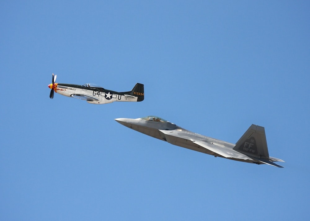 white-and-black monoplane and gray jet