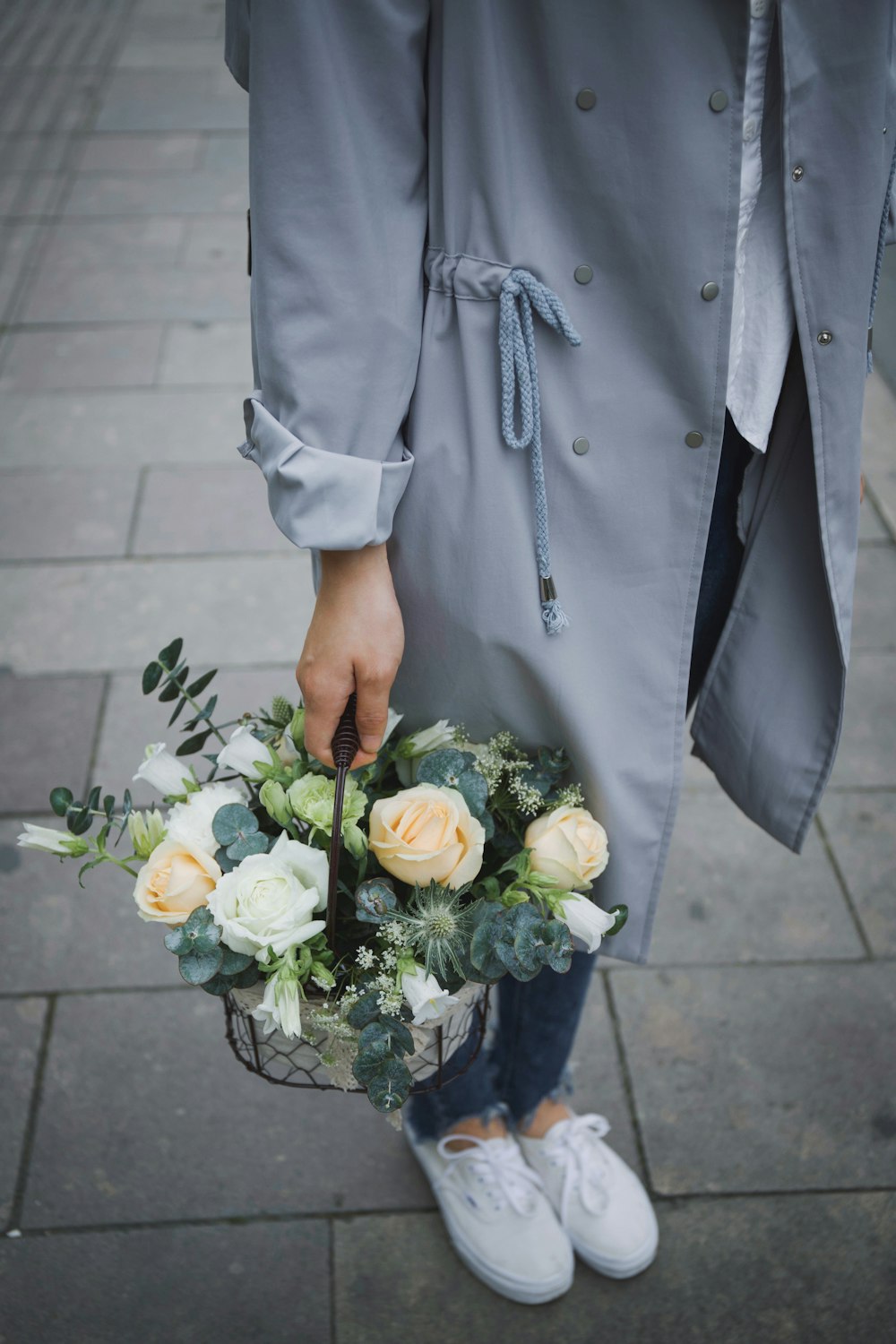 woman holding basket of flowers