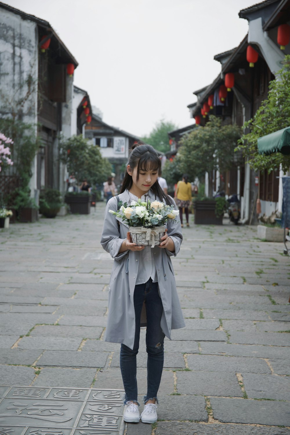 woman holding flowers on basket