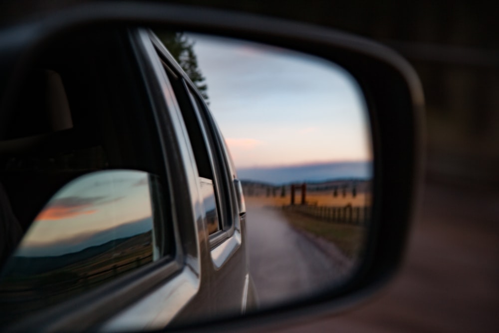 wing mirror reflecting road on desert