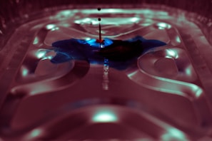 Close-up of colorful ink droplets swirling on a glossy surface