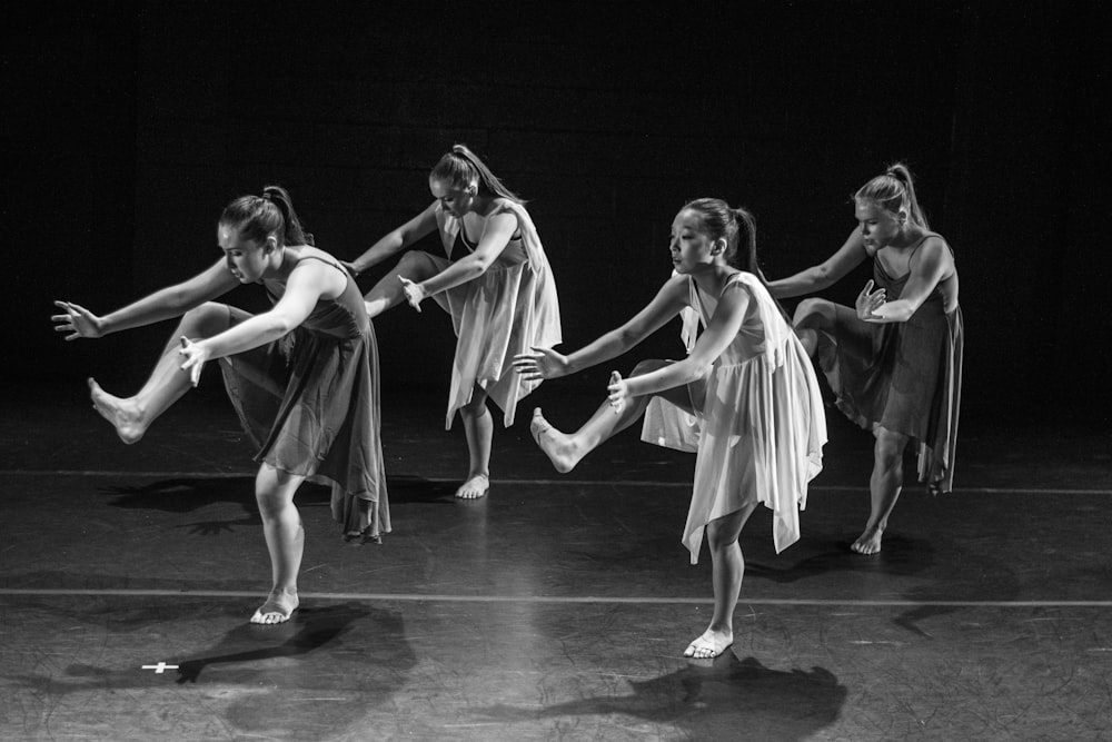 four women dancing grayscale photography