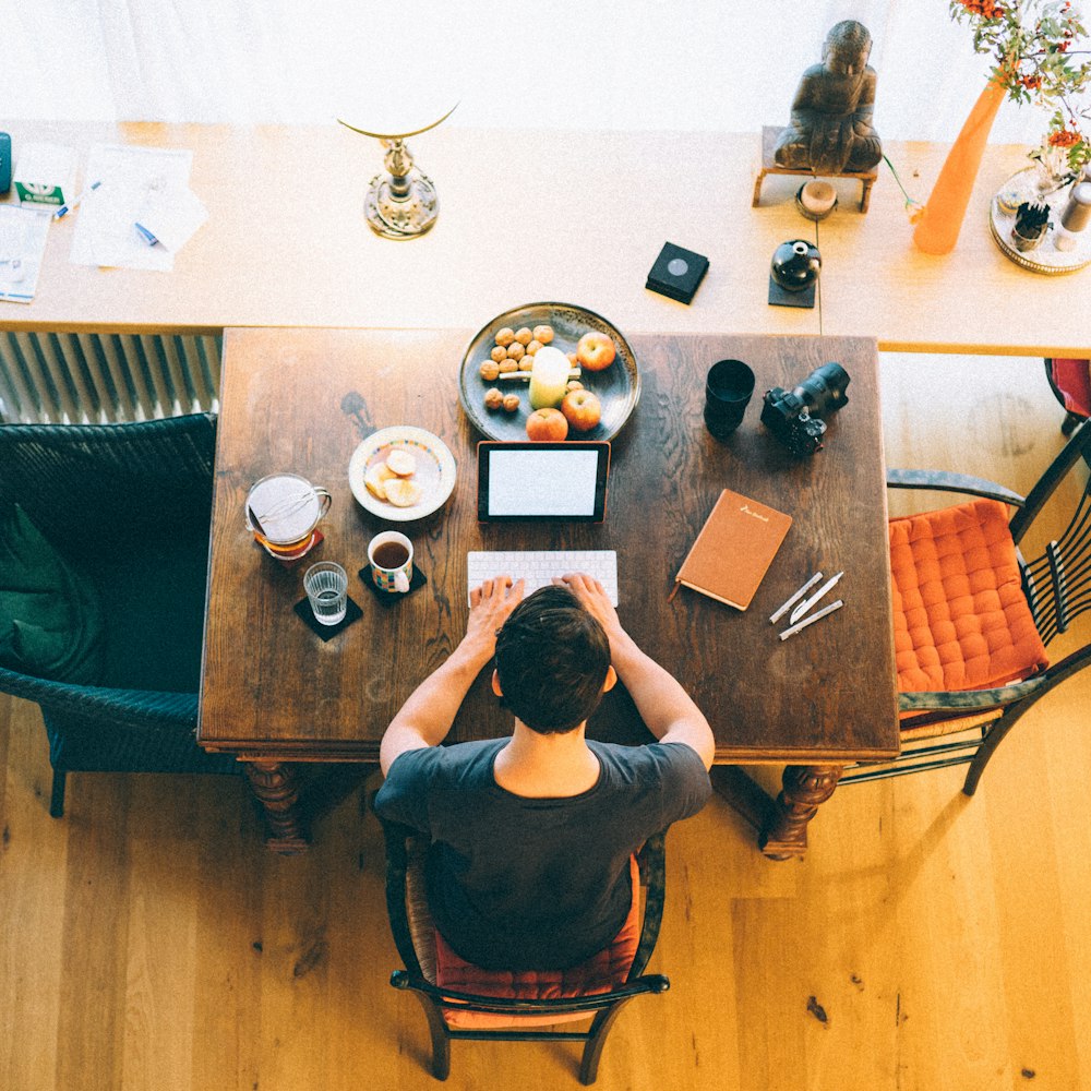 man typing on keyboard inside room