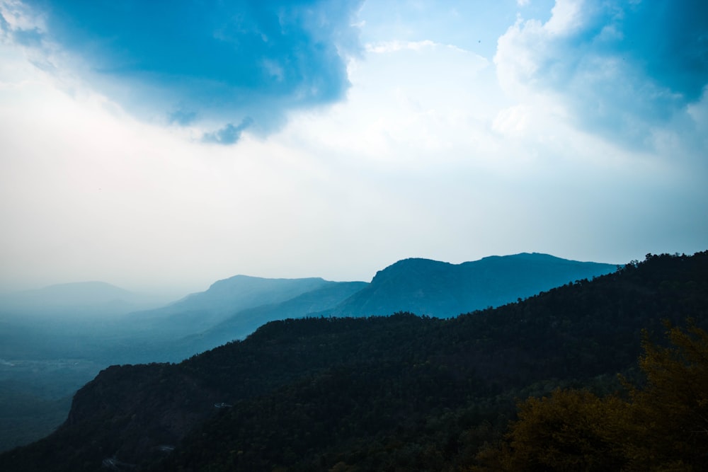 time lapse photography of mountain under clouds