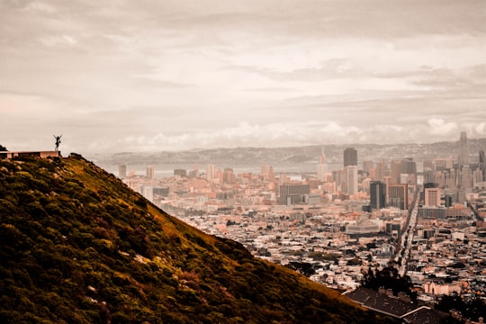 person on mountain overlooking high rise buildings in Twin Peaks United States