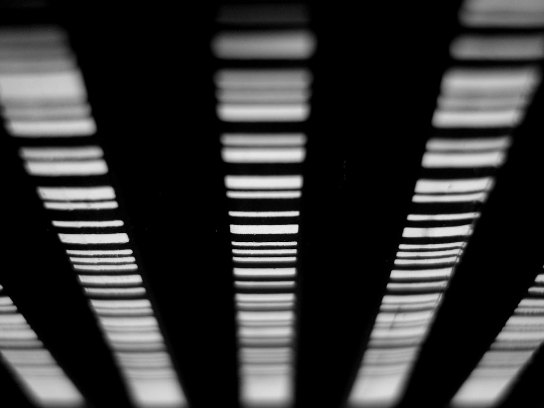 a black and white photo of a metal structure, Pencils