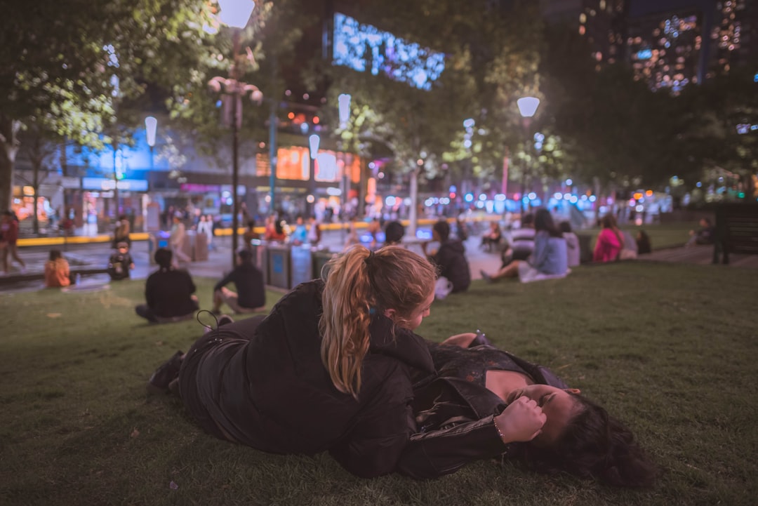 two woman lying on the grass