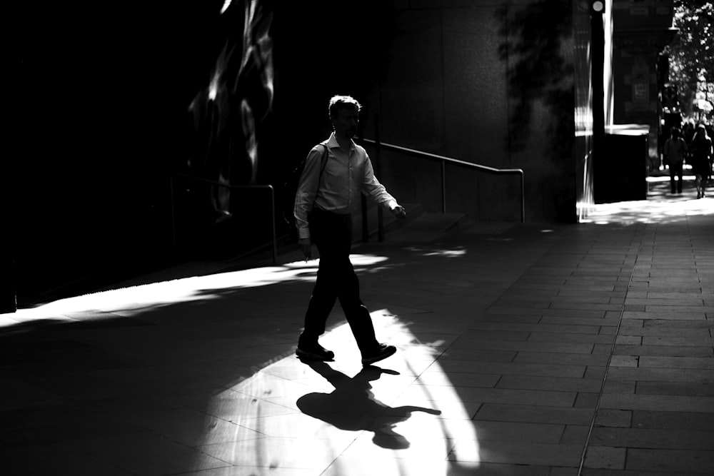 person walking on concrete pavement