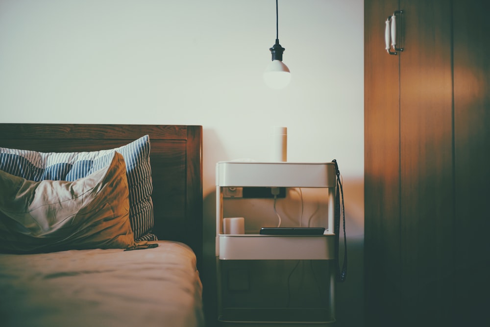 white pendant lamp near bed