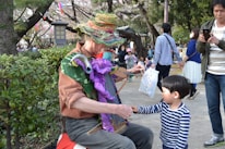 Elder and child together, passing down German folk songs in a cozy community setting.