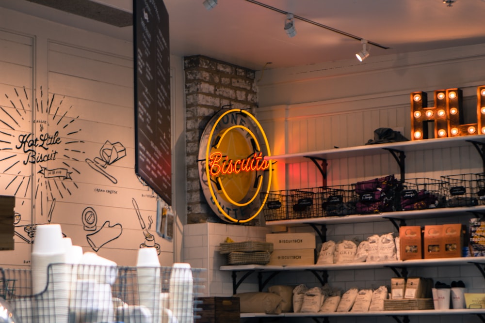 red and yellow Biscuits neon light signage hanged on gray brick wall