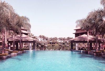 Outdoor infinity pool overlooking a lush garden oasis.