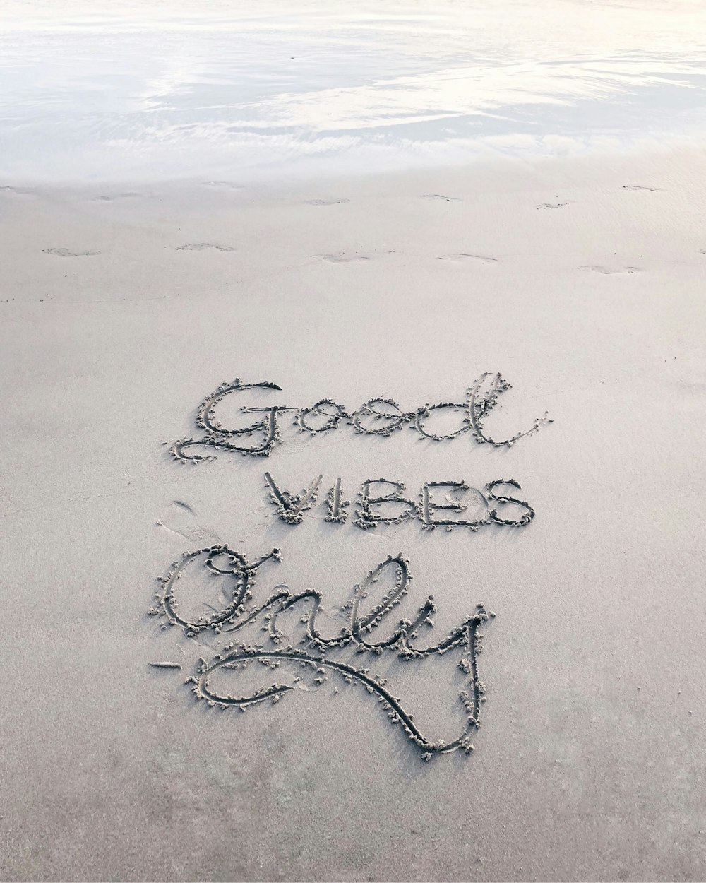 Good Vibes Only sand text