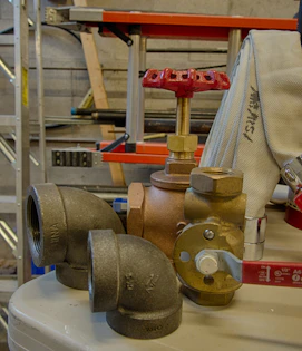 Plumbers fitting copper pipes and sanitary ware in a modern bathroom renovation.
