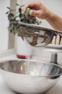 Hands mixing organic powders in a clean, modern workspace.