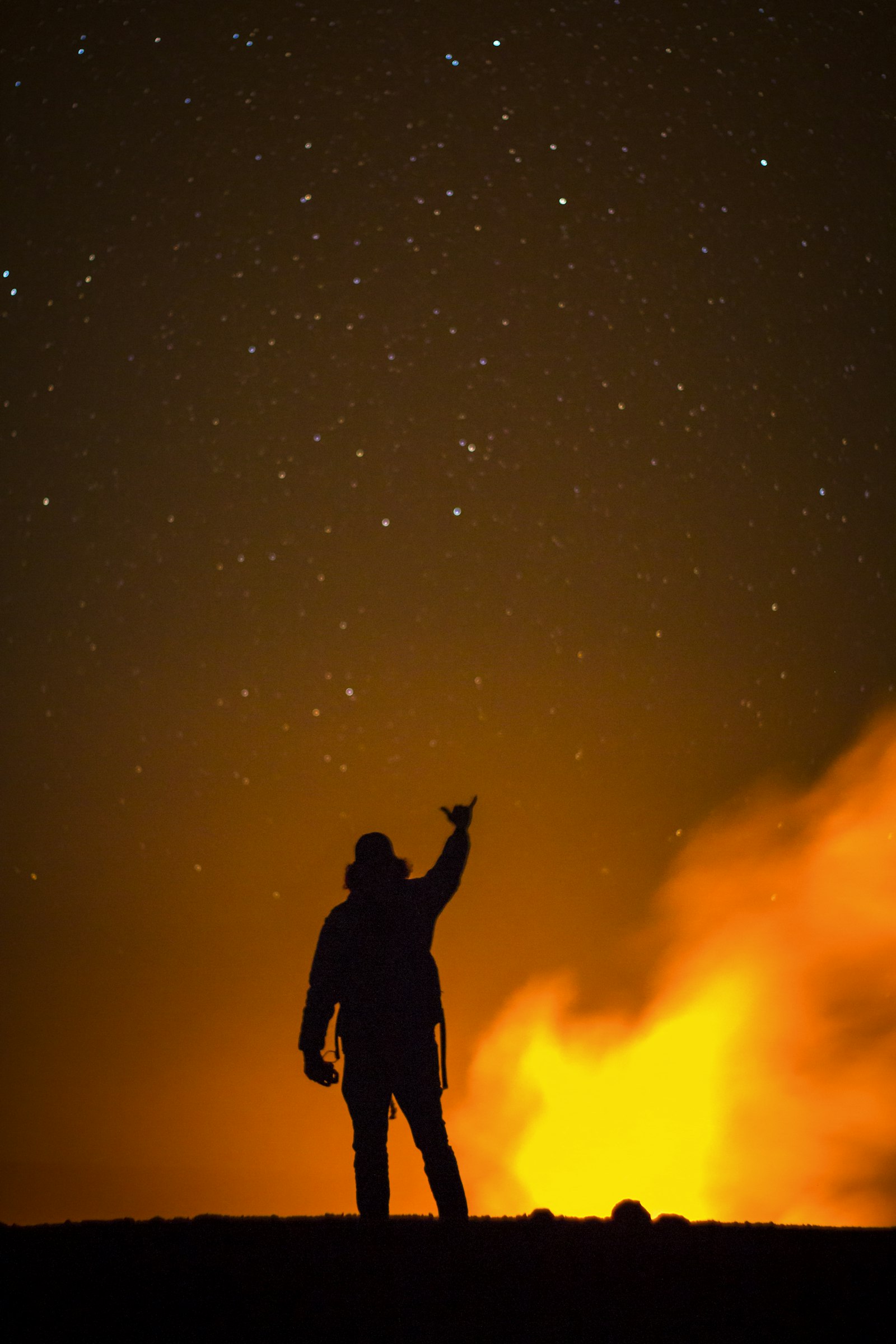 Canon EOS 70D + Yongnuo YN 50mm f/1.8 sample photo. Silhouette of man raising photography