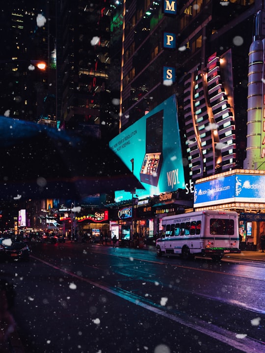 white bus in city street at night in Manhattan United States