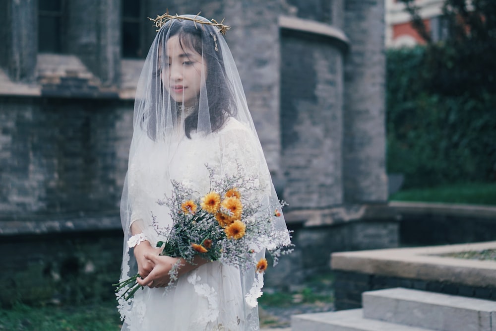 woman holding orange flower bouquet