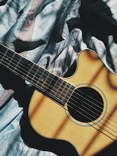 brown cut-away guitar