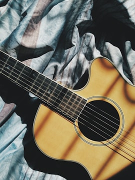 brown cut-away guitar