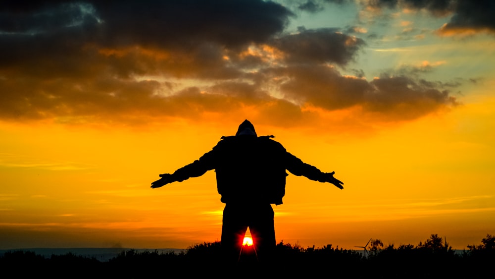 silhouette of man spreading its arm