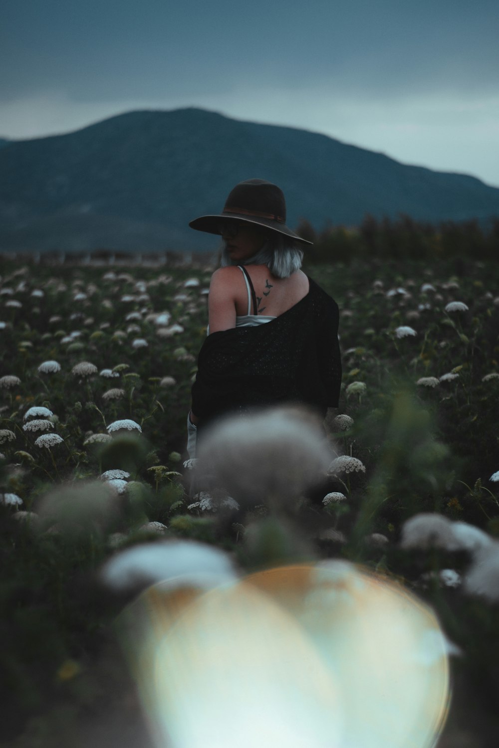 woman stating on flower field