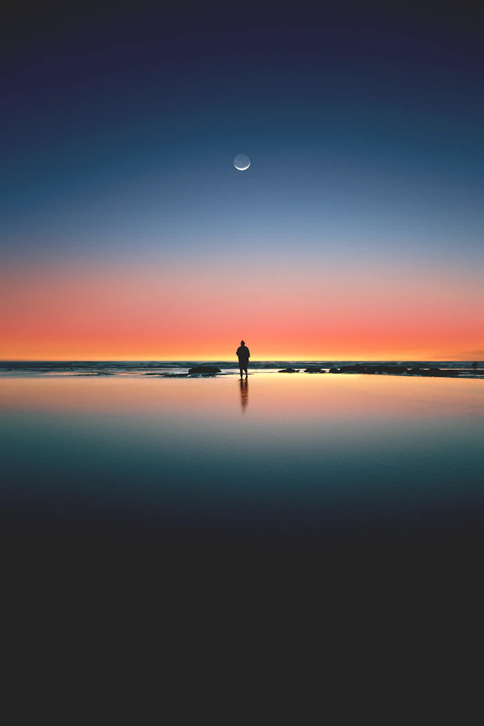 A lone silhouette on the seashore at dusk, a fiction scene about a final decision