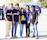 A group of young adults wearing colorful custom t-shirts outdoors at a church retreat.
