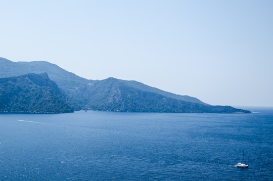 landscape photography of sea and mountains under blue calm sky in Fethiye Turkey