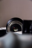 A close-up of a camera lens focused on a scene.