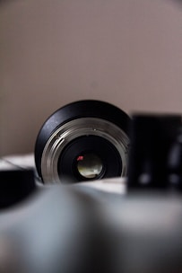 A close-up of a camera lens focusing on a wedding scene.