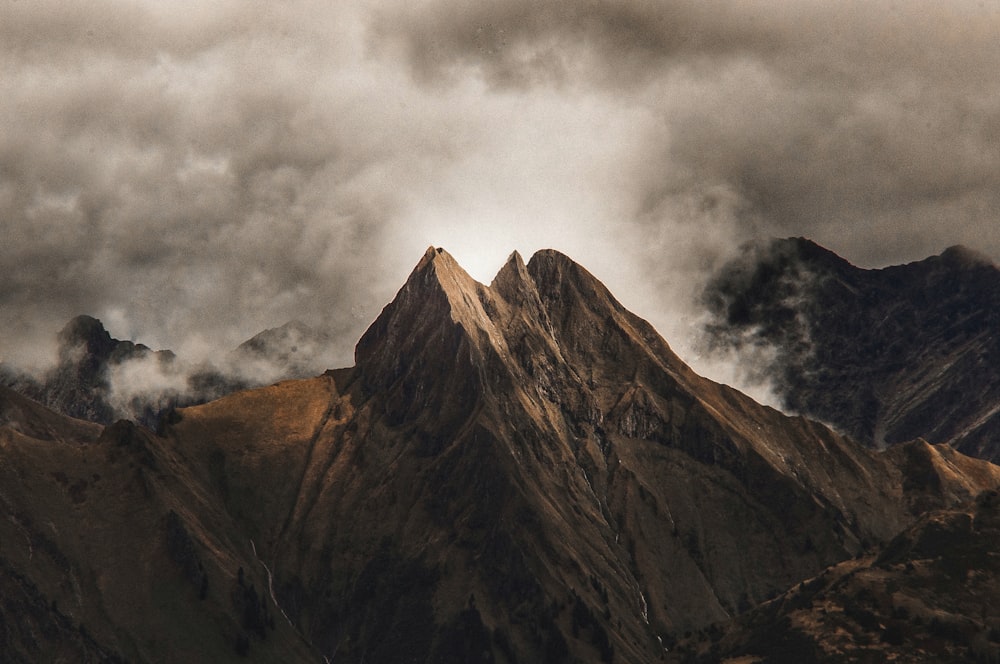 brown mountain with clouds